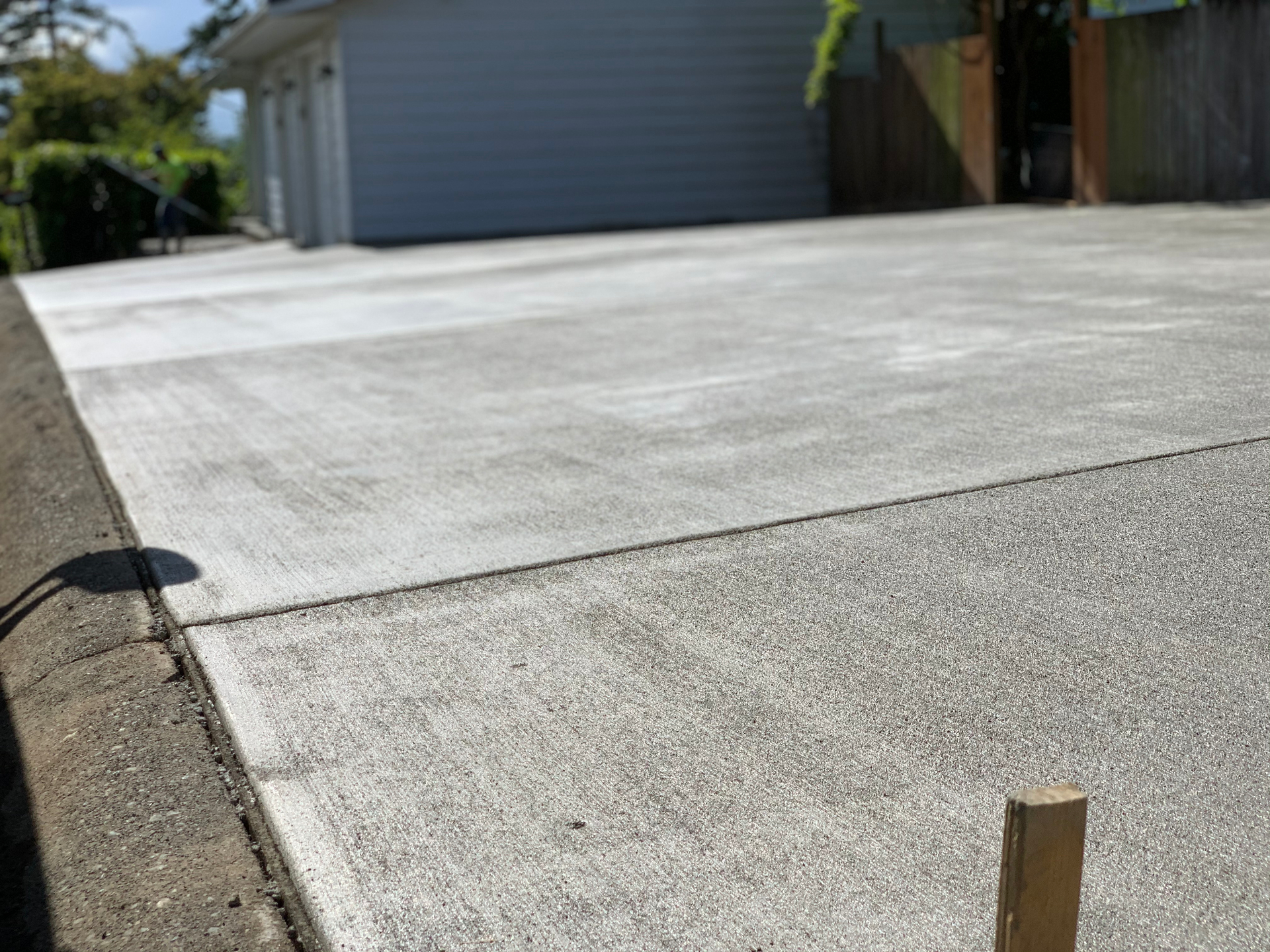 Freshly poured residential concrete driveway by Caliber Strategies